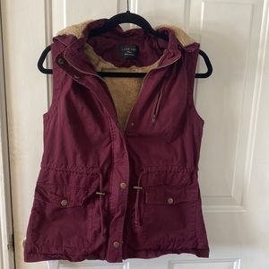 womenms maroon zip up vest with hood and front pockets, adjustable waist